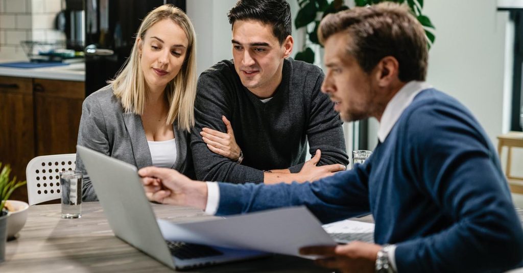 Couple reviewing borrowing options with a financial professional at home