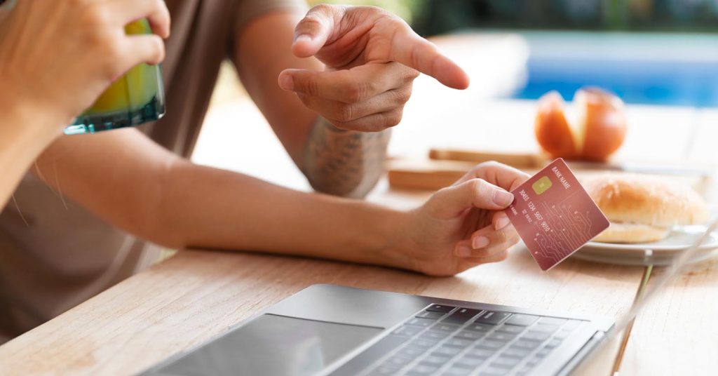 Person reviewing a credit card offer with someone before making a balance transfer