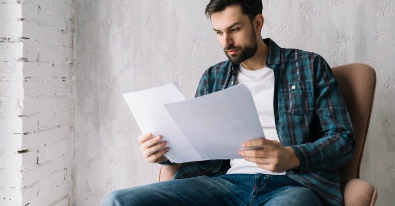 Man reading loan documents and comparing Buy Now, Pay Later with a personal loan.