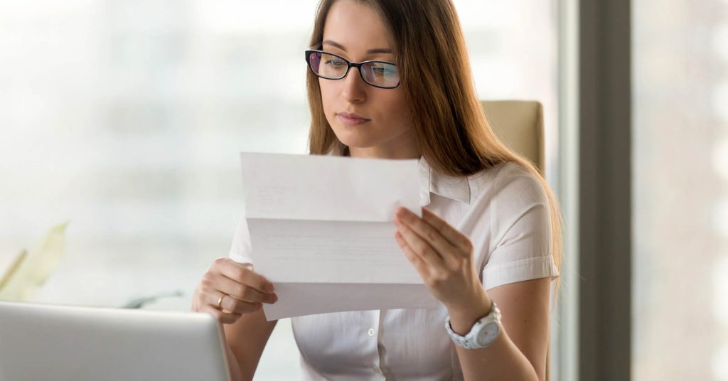 Woman reviewing legal and financial documents about wage garnishment