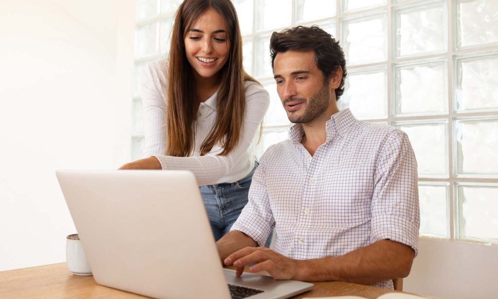 Person reviewing financial plans and using online calculators