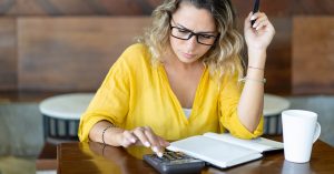 Woman calculating whether to pay off a personal loan early