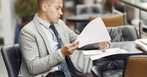 Man reviewing personal loan documents and fees before signing