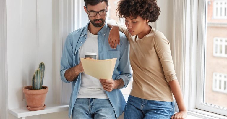 Couple reviewing mortgage refinance options at home