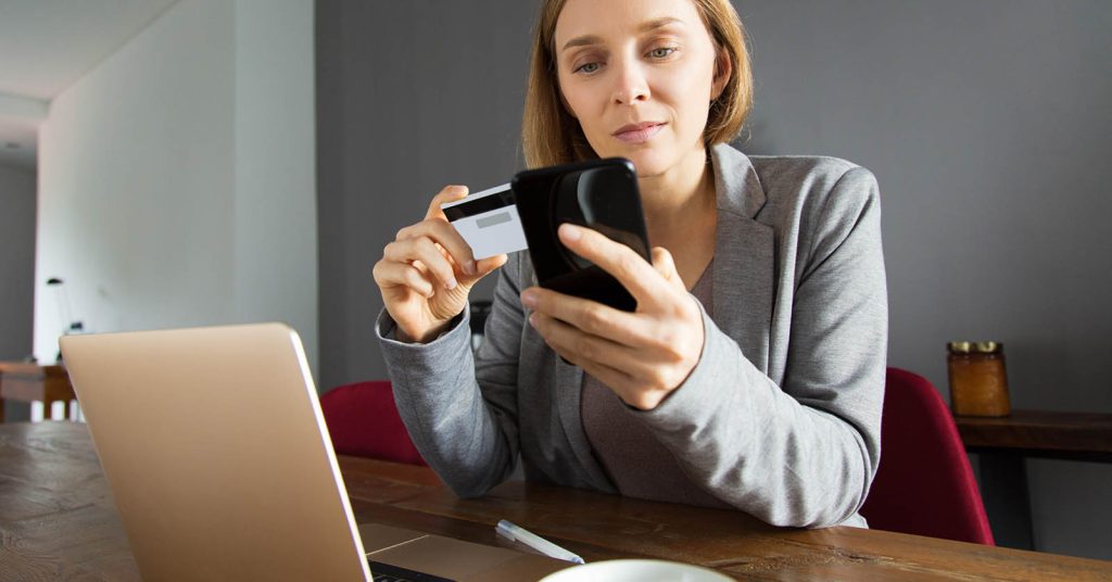 Woman making a loan payment online on her phone
