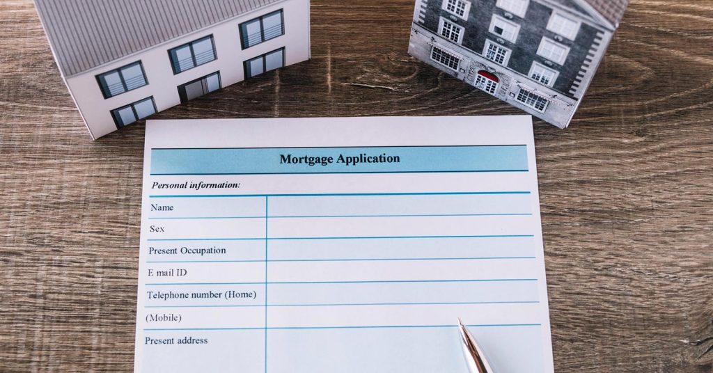 Mortgage application form and homebuying documents on a table