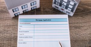 Mortgage application form and homebuying documents on a table