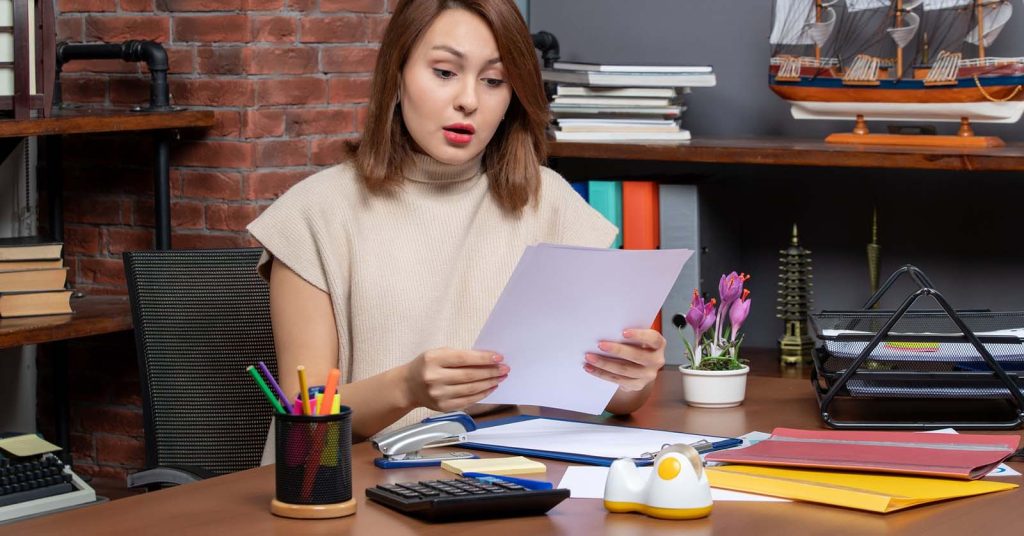 Borrower reviewing student loan refinance documents and comparing terms