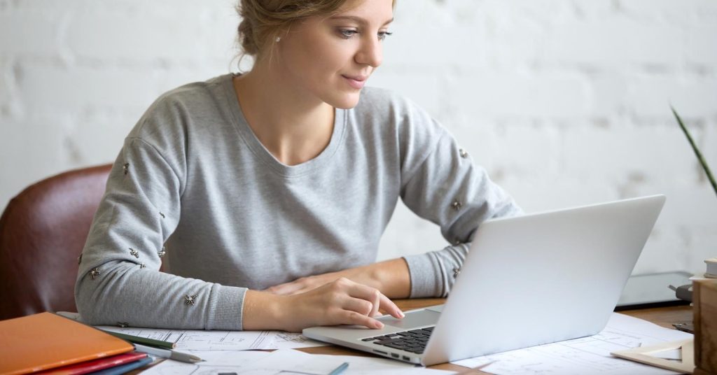 Student reviewing student loan interest and repayment costs on a laptop