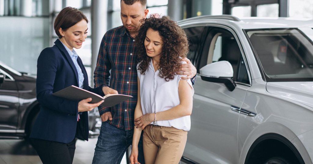 Couple discussing car financing terms while considering a longer auto loan