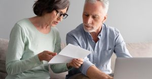 Two borrowers reviewing joint consolidation loan separation documents