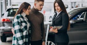 Couple choosing a car in a showroom while discussing options for an upside-down auto loan