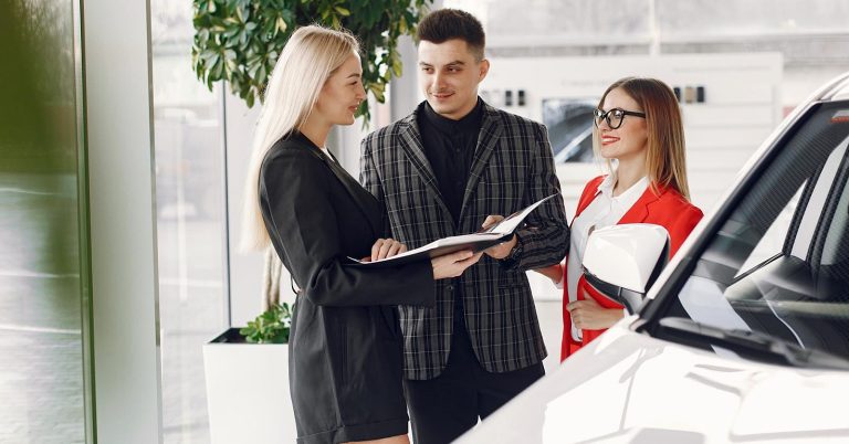 People discussing car loan terms and negotiation options in a showroom