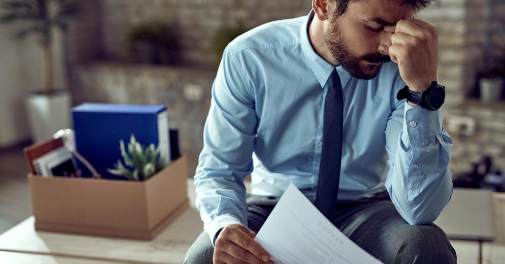 Man reviewing legal debt collection papers after being sued by a debt collector
