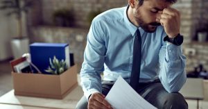 Man reviewing legal debt collection papers after being sued by a debt collector