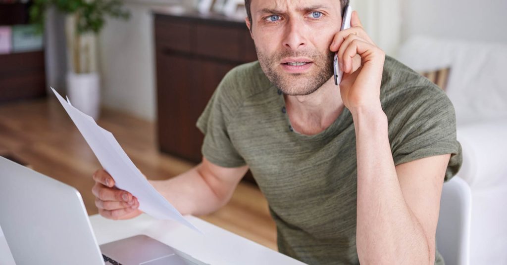 Man calling for help while reviewing default judgment debt paperwork