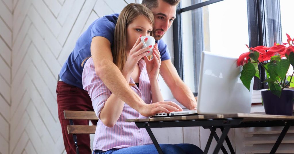Couple reviewing bills together and deciding which debts to pay first