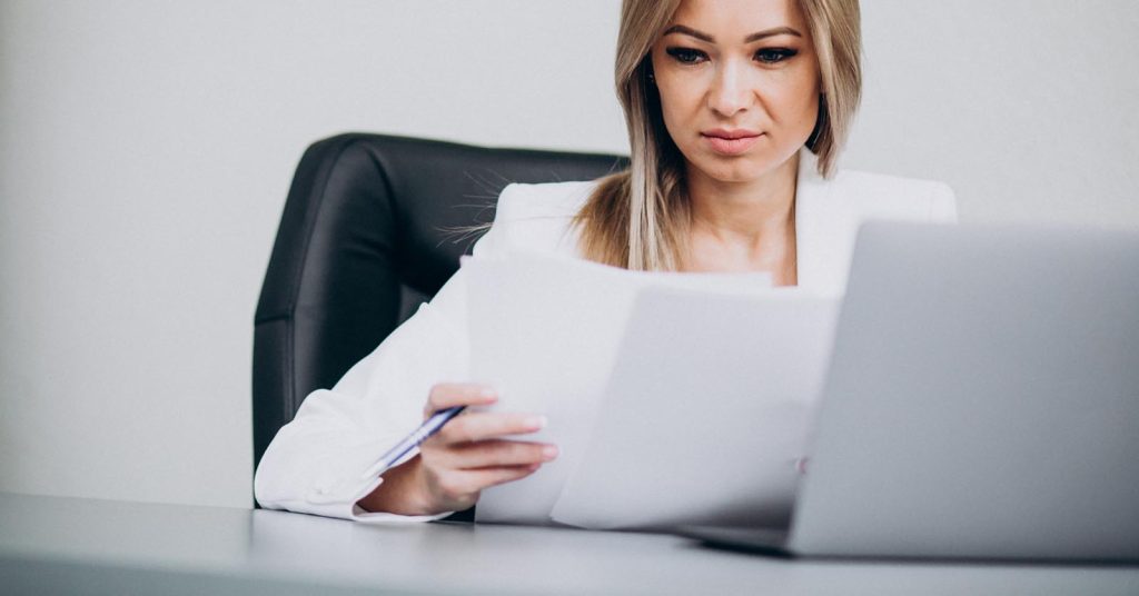 Woman checking how bankruptcy and discharged accounts appear on her credit reports