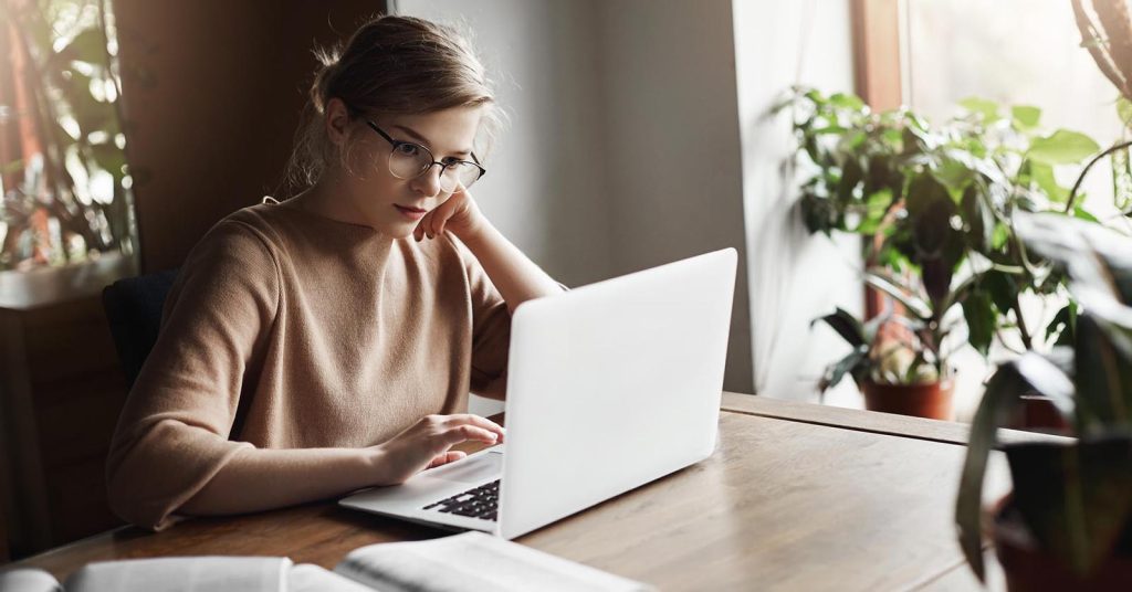 Woman comparing bankruptcy and debt settlement options online