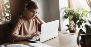 Woman comparing bankruptcy and debt settlement options online