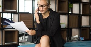 Woman reviewing a collection letter while speaking on the phone