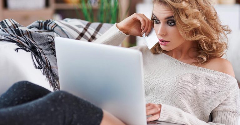 Woman comparing the costs of filing bankruptcy on her laptop