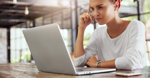 Woman reviewing an online credit card debt forgiveness offer