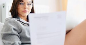 Woman reviewing a credit card statement after a missed payment