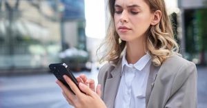 Concerned woman checking repeated debt collection calls on her phone