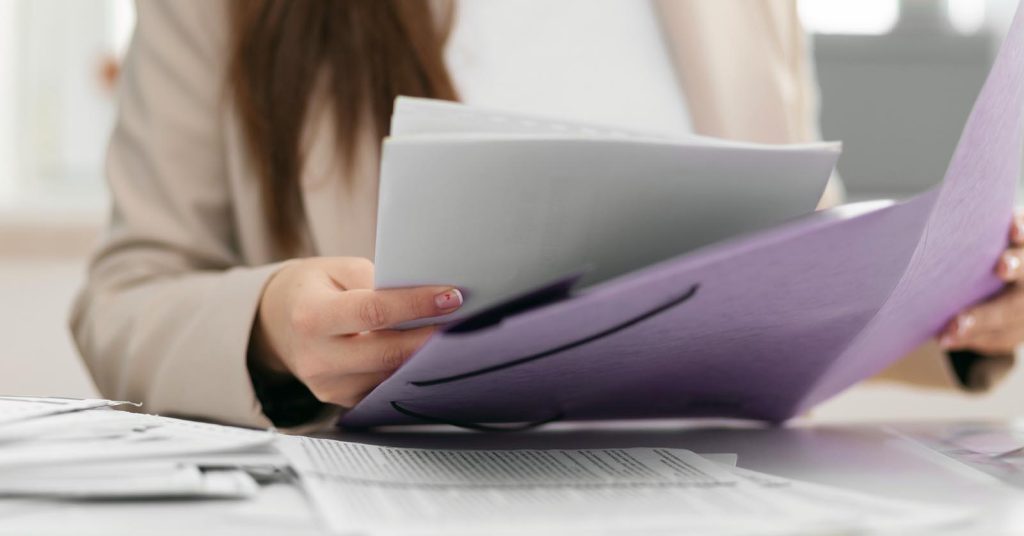 Woman reviewing an itemized medical bill and supporting documents