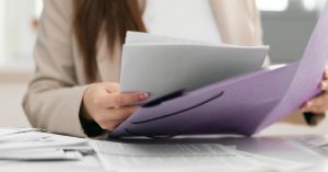Woman reviewing an itemized medical bill and supporting documents