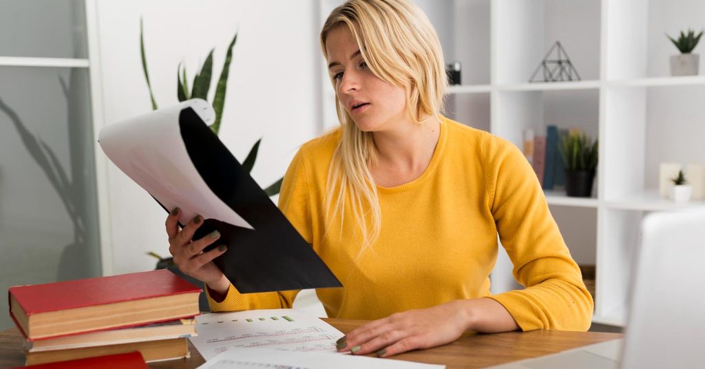 Woman reviewing auto loan documents before deciding how bankruptcy will affect her car