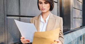 Woman reviewing mortgage documents before deciding how bankruptcy will affect her home