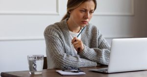 Woman reviewing the terms of a medical credit card on her laptop