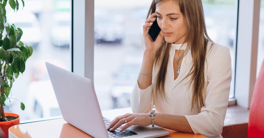 Woman reviewing a medical collection account while speaking with a debt collector