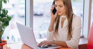 Woman reviewing a medical collection account while speaking with a debt collector