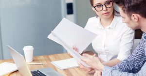 Woman discussing credit card debt options while reviewing account documents