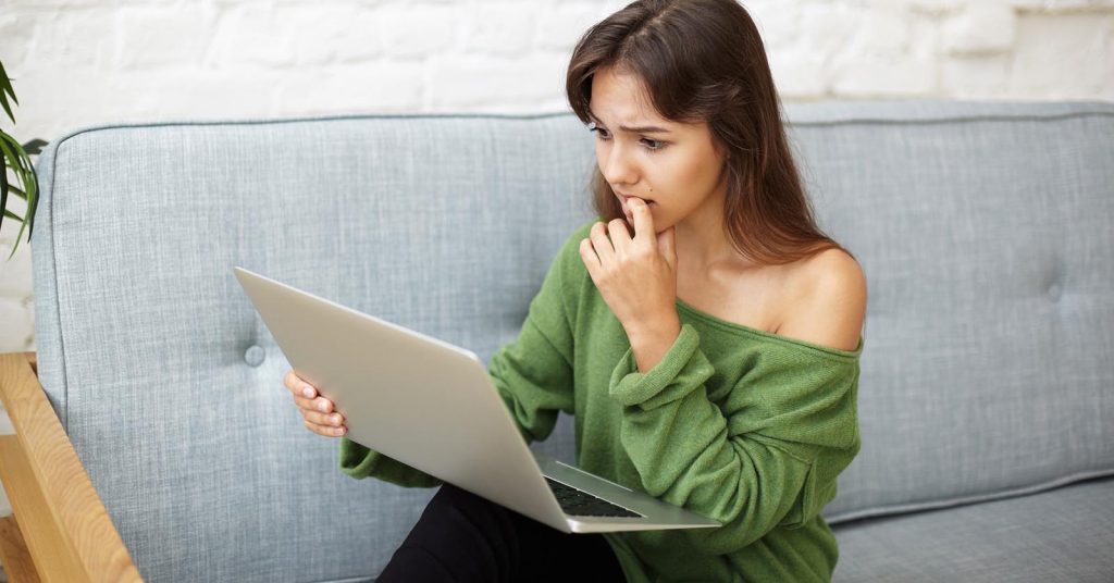 Woman reviewing an unexpected out-of-network medical bill online