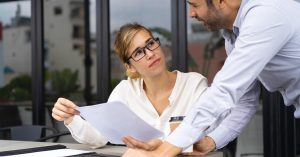 Consumer reviewing a charged-off credit card debt settlement with a financial professional