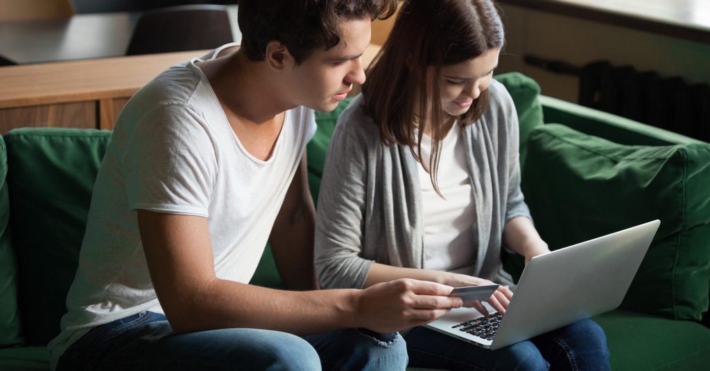 Married couple reviewing a credit card account to understand who is responsible for the debt