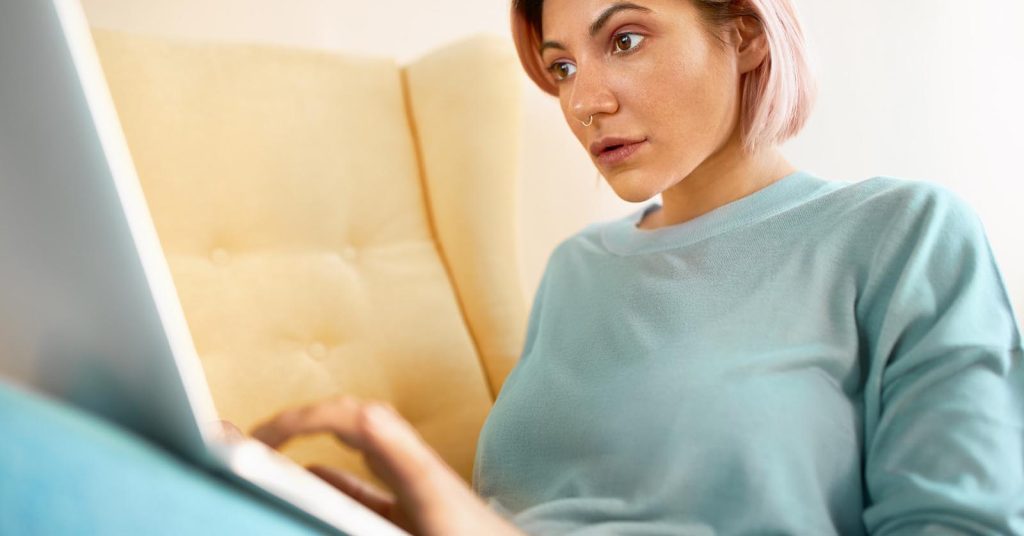 Woman concerned about unpaid medical bills while reviewing her account online