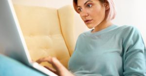 Woman concerned about unpaid medical bills while reviewing her account online