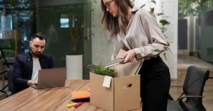 Employee packing personal belongings after leaving a job