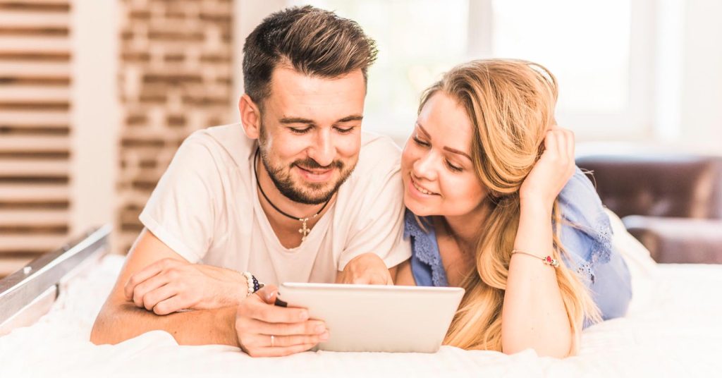 Two people looking at a tablet together