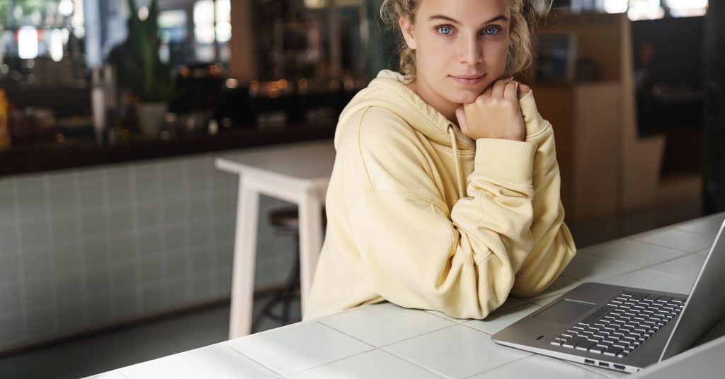 Teenager learning about credit at a laptop