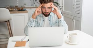 Concerned parent looking at a laptop after discovering a possible identity theft issue