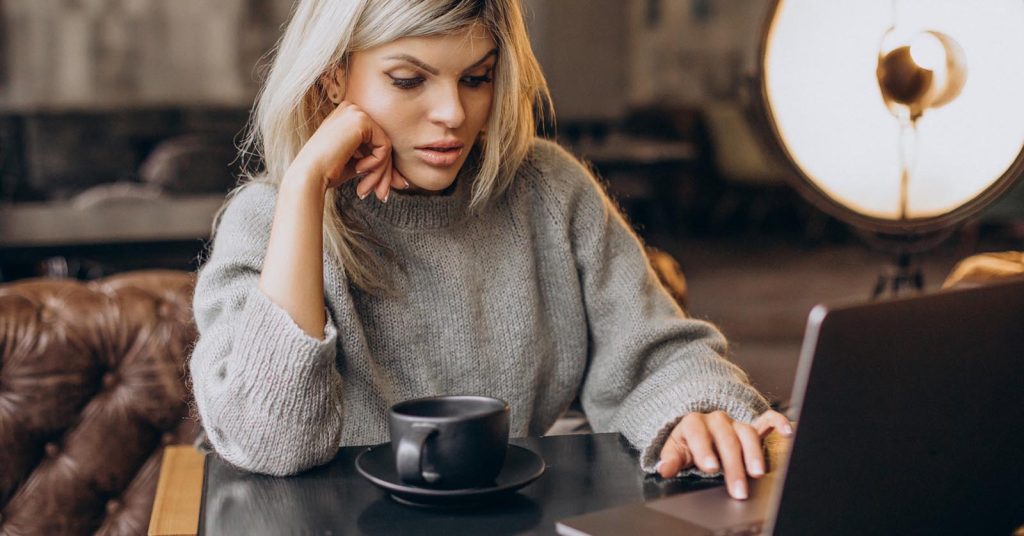 Freelancer researching a target market and positioning services on a laptop