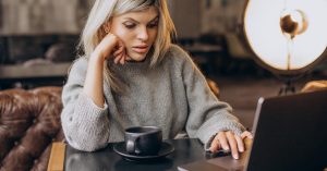 Freelancer researching a target market and positioning services on a laptop