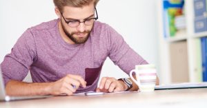 Man reviewing debt consolidation figures and possible credit score changes
