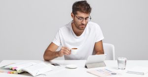 Woman comparing documents before applying for a debt consolidation loan